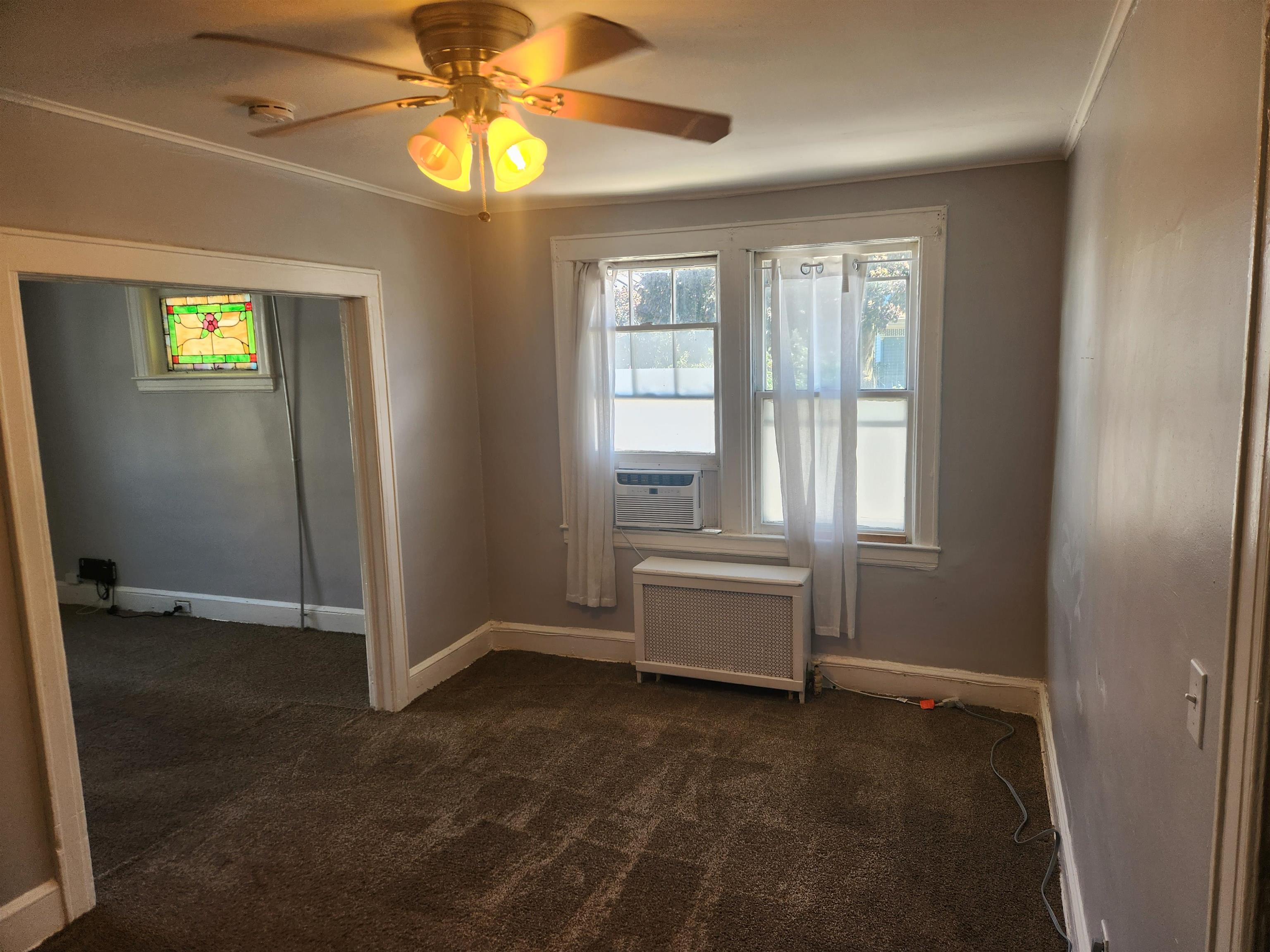 261 Centre Avenue, Unit 1 Secaucus, NJ 07094 - Photo 5 of 11 an empty room with windows and ceiling fan