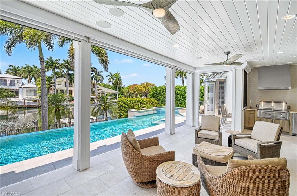 1888 6th Street South Naples, FL 34102 - Photo 15 of 37 a balcony with furniture and a garden