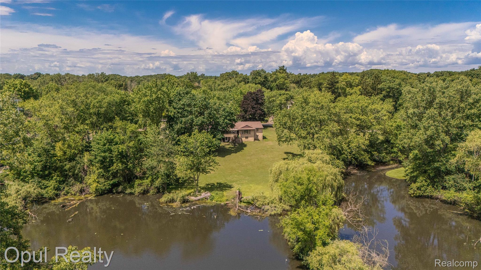 6455 Norham Road Bloomfield Hills, MI 48301 - Photo 80 of 93 Waterfront property featuring a single-story residence, expansive green lawn, and mature trees