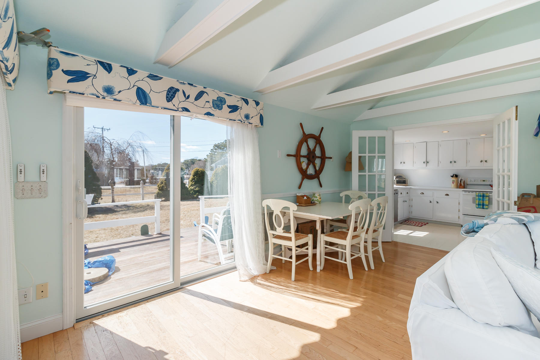 5 Deans Hollow Road Mashpee, MA 02649 - Photo 8 of 44 a dining room with wooden floor a glass table and chairs