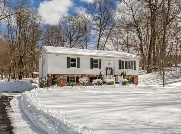 a view of a house with snow on the side of it