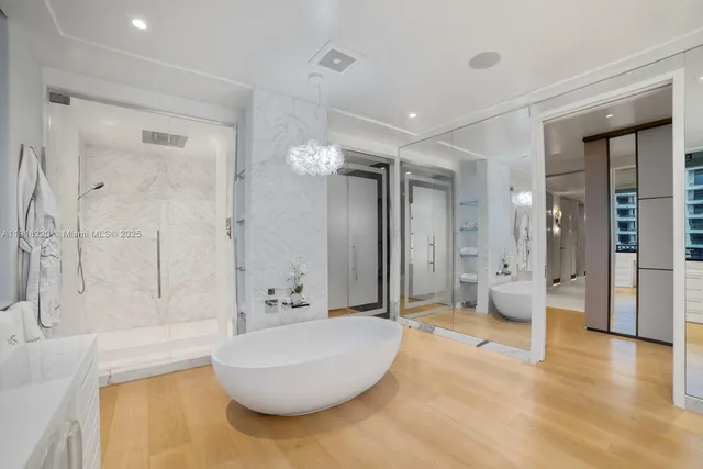 a spacious bathroom with a tub sink and mirror