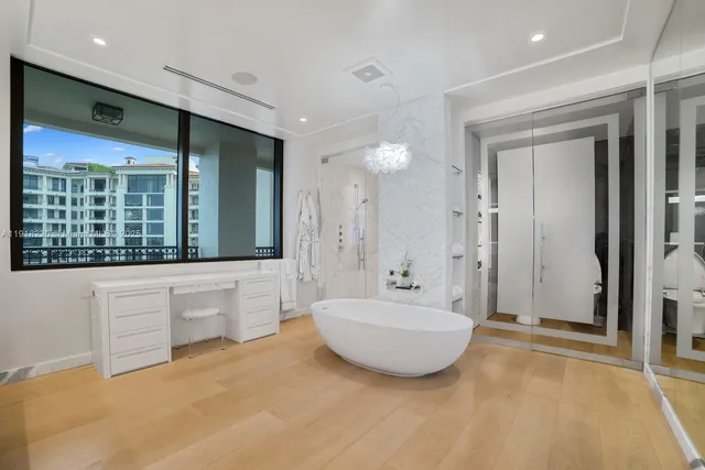 a view of a bathroom with a tub sink shower and mirror