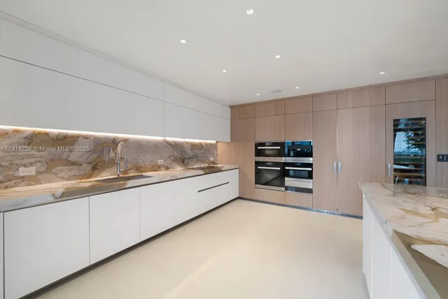 a kitchen with granite countertop a stove and a sink