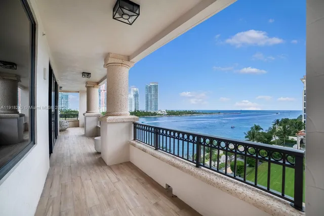 a view of a balcony with chairs and wooden floor