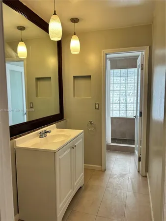 a bathroom with a sink a vanity and a mirror