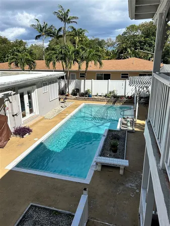 swimming pool view with a seating space