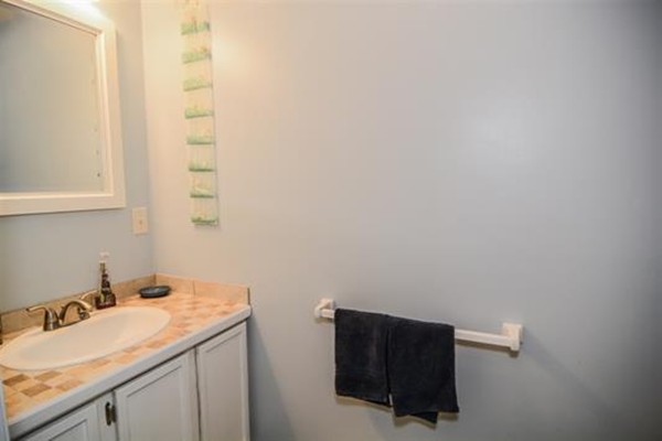 4 Belknap Road Hudson, NH 03051 - Photo 18 of 30 a bathroom with a granite countertop sink and a mirror