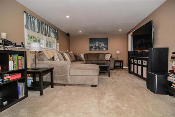 4 Belknap Road Hudson, NH 03051 - Photo 21 of 30 a living room with furniture and a flat screen tv