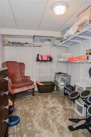 4 Belknap Road Hudson, NH 03051 - Photo 23 of 30 a room with storage and a chair