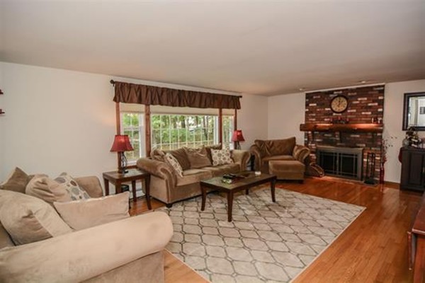 4 Belknap Road Hudson, NH 03051 - Photo 3 of 30 a living room with furniture a fireplace and wooden floor