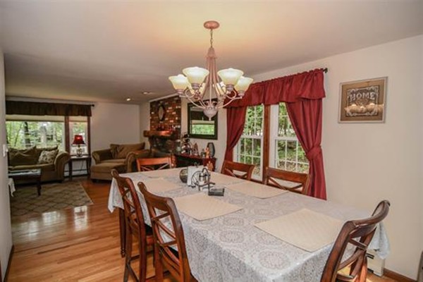 4 Belknap Road Hudson, NH 03051 - Photo 6 of 30 a view of a dining room with furniture a chandelier and wooden floor
