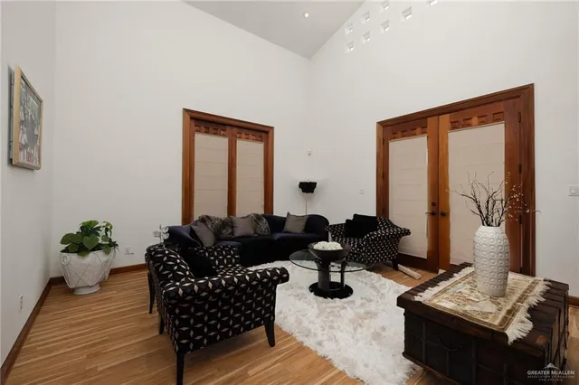 a living room with furniture and wooden floor