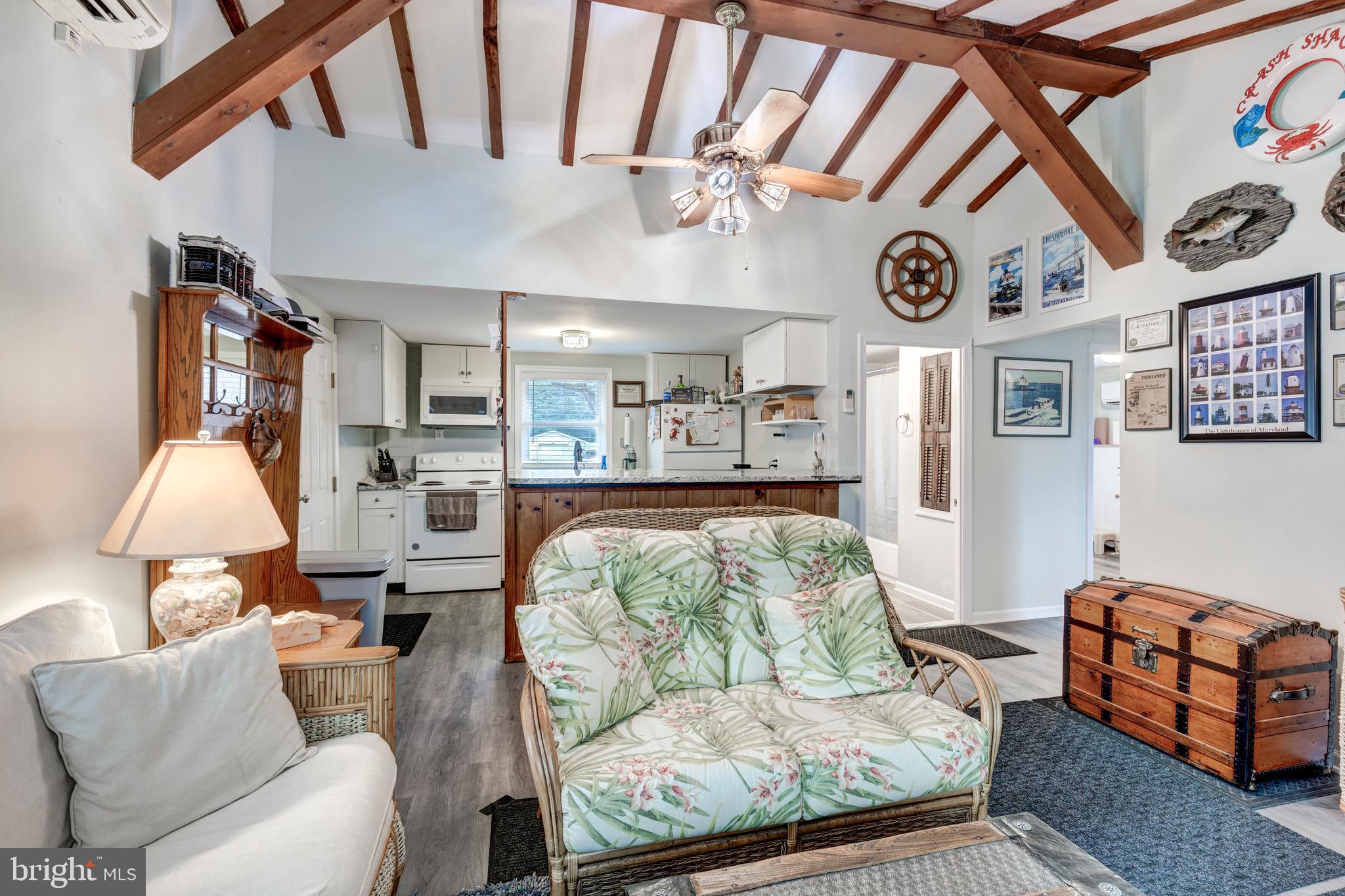 648 Chester River Beach Road Grasonville, MD 21638 - Photo 20 of 62 a living room with furniture and a clock