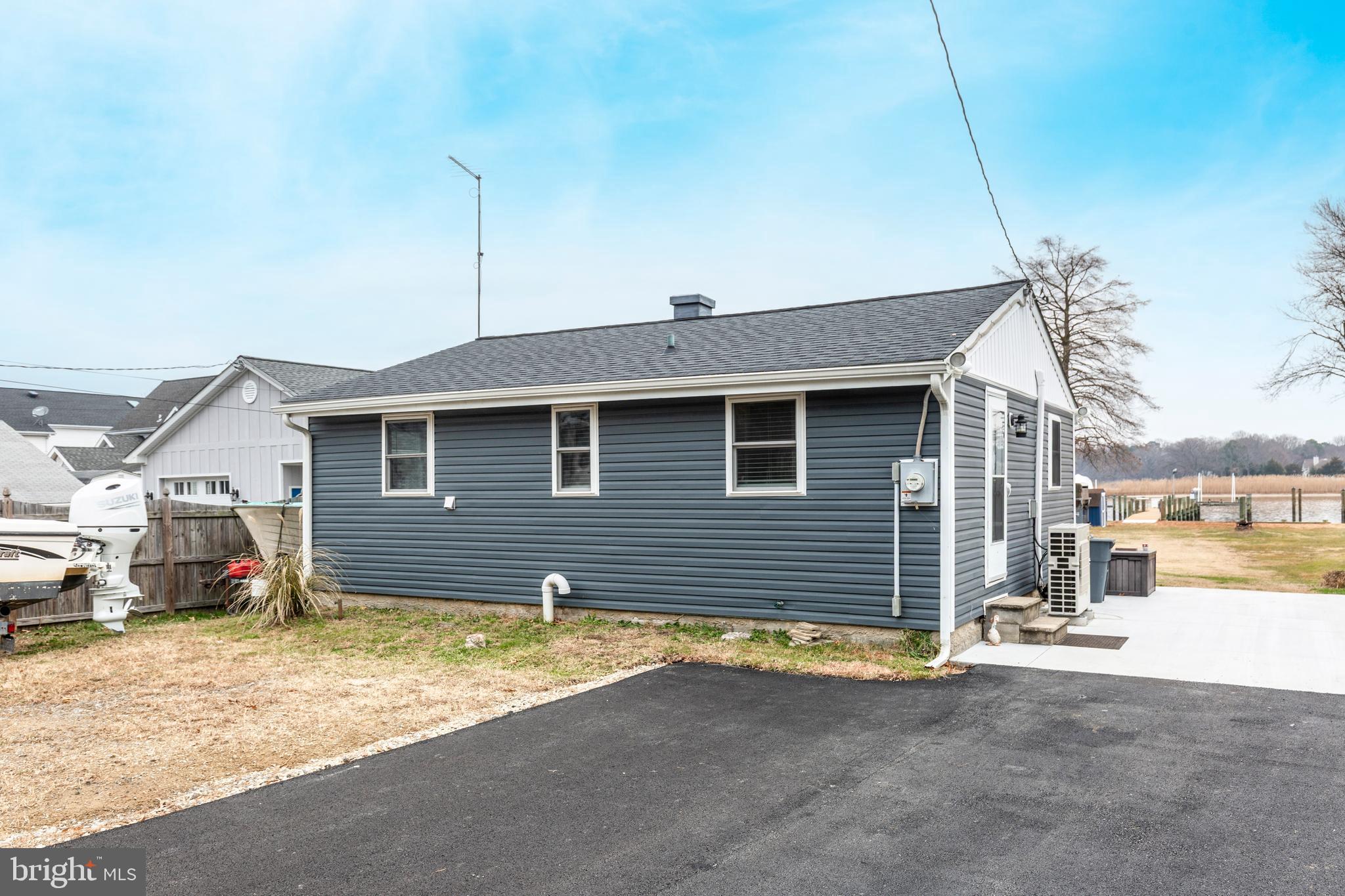 648 Chester River Beach Road Grasonville, MD 21638 - Photo 57 of 62 a front view of a house with a yard