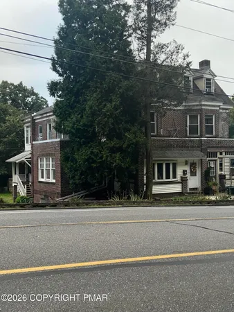 a front view of a house with a garden