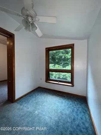 a view of a room with gym equipment and a window