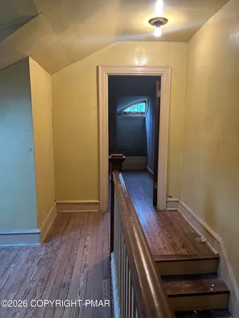 a view of gallery with wooden floor
