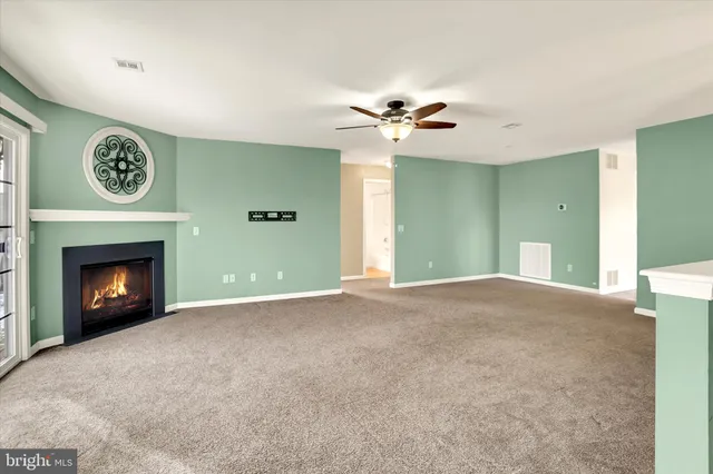 a view of a room with a fireplace and fan