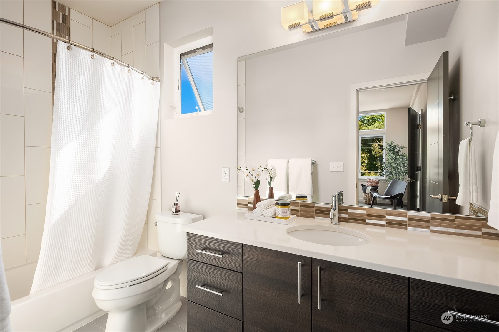 417 North 50th Street Seattle, WA 98103 - Photo 16 of 30 a bathroom with a double vanity sink toilet and a mirror