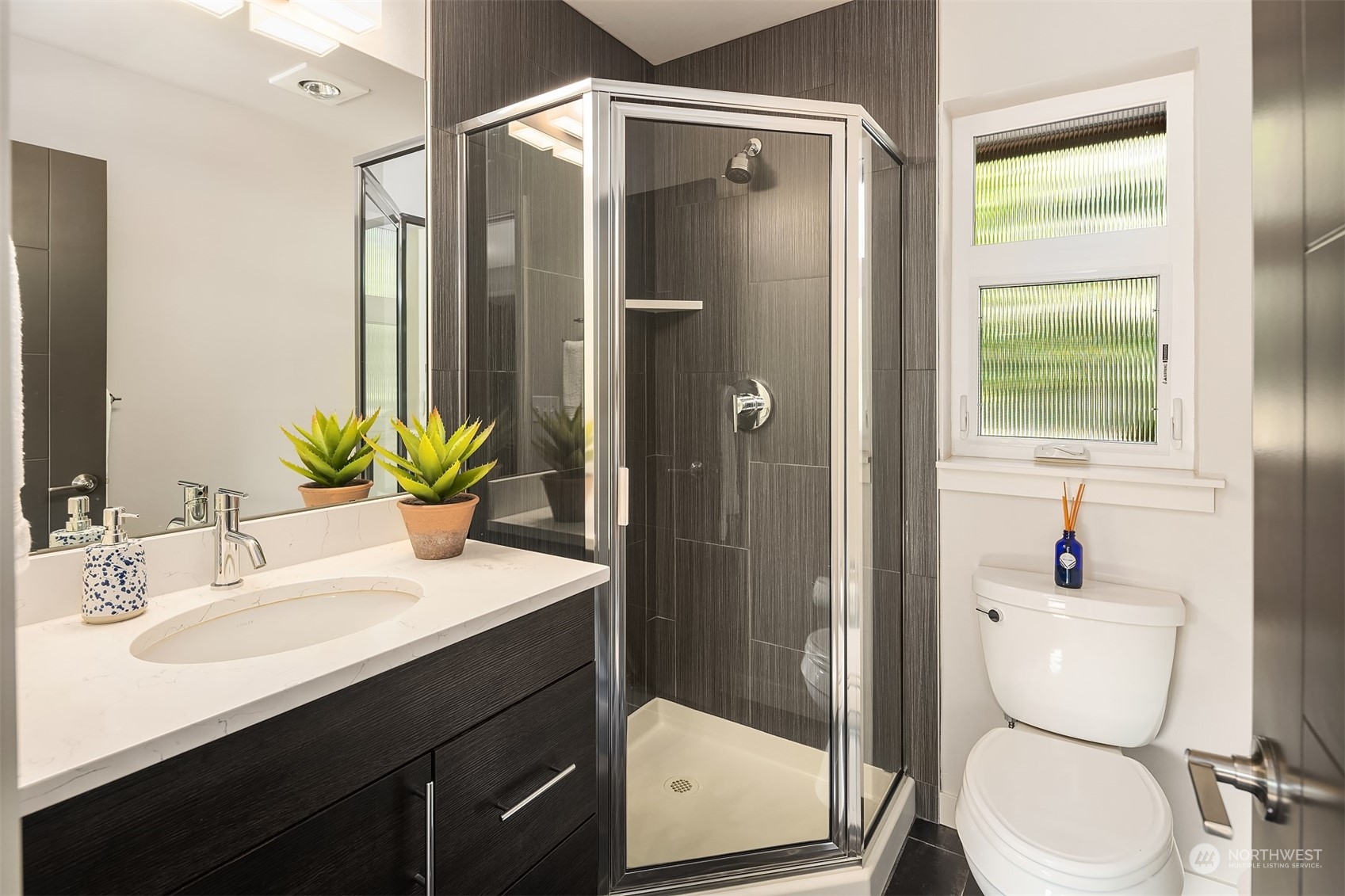 417 North 50th Street Seattle, WA 98103 - Photo 25 of 30 a bathroom with a sink toilet and shower