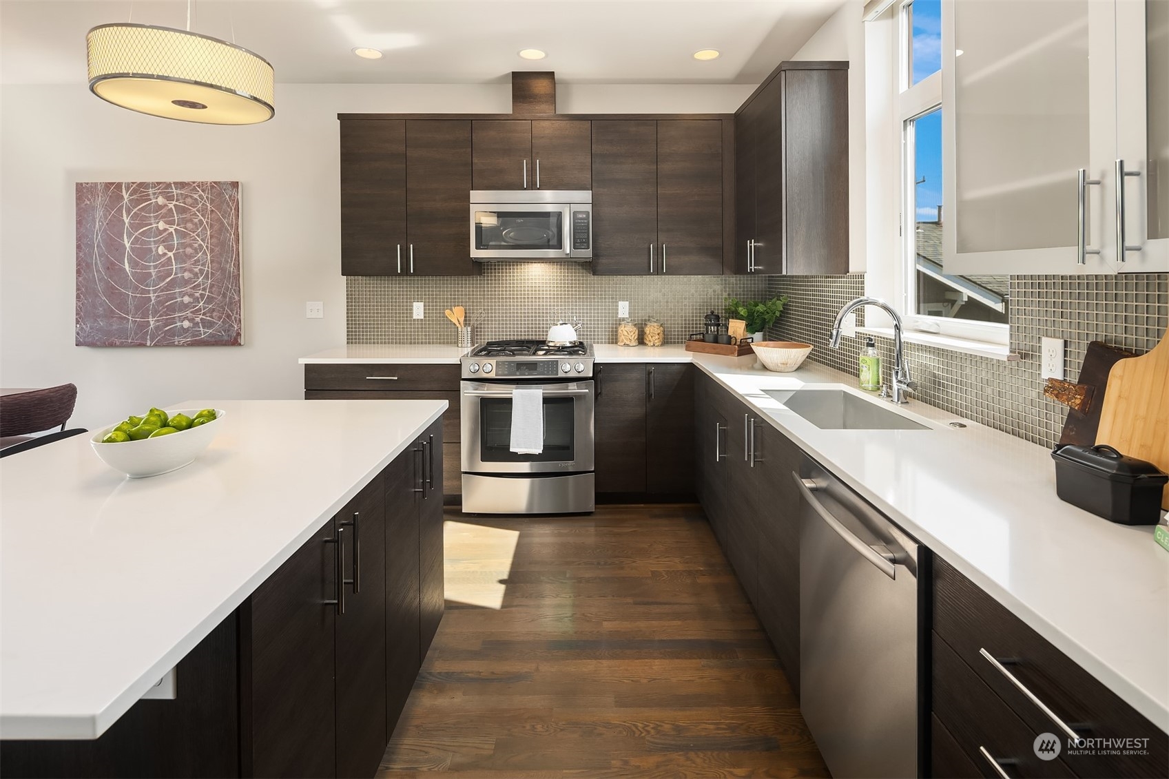 417 North 50th Street Seattle, WA 98103 - Photo 5 of 30 a kitchen with stainless steel appliances granite countertop a sink stove and refrigerator