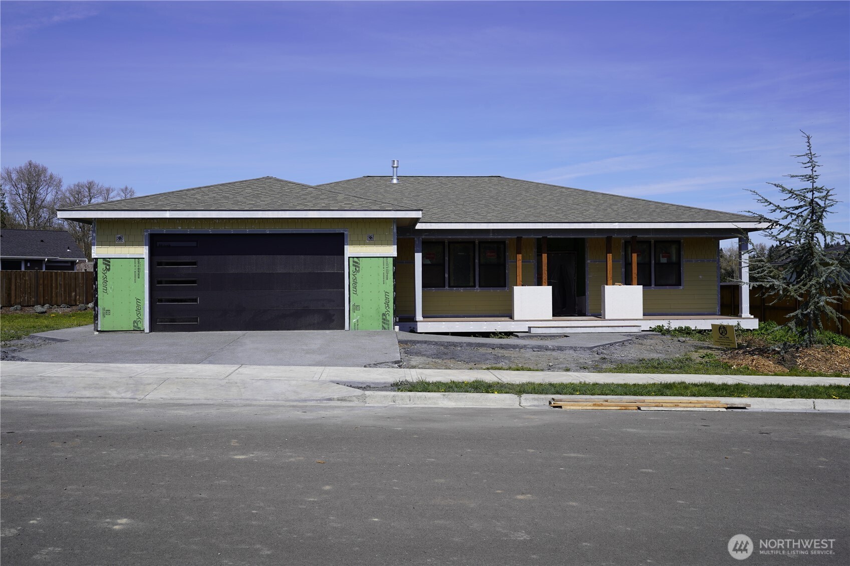 a front view of a house with a garden and yard