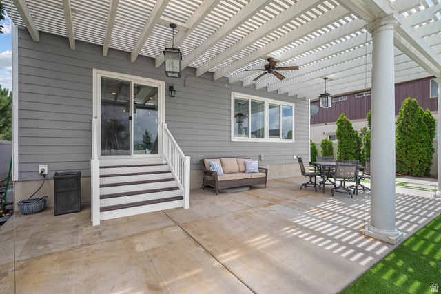 955 Delorean Lane Midvale, UT 84047 - Photo 45 of 47 Expansive concrete patio with a white pergola overhead