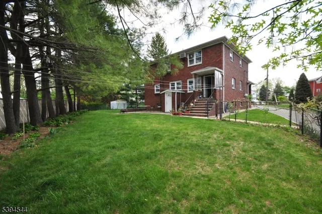 a view of a house with a yard and sitting area