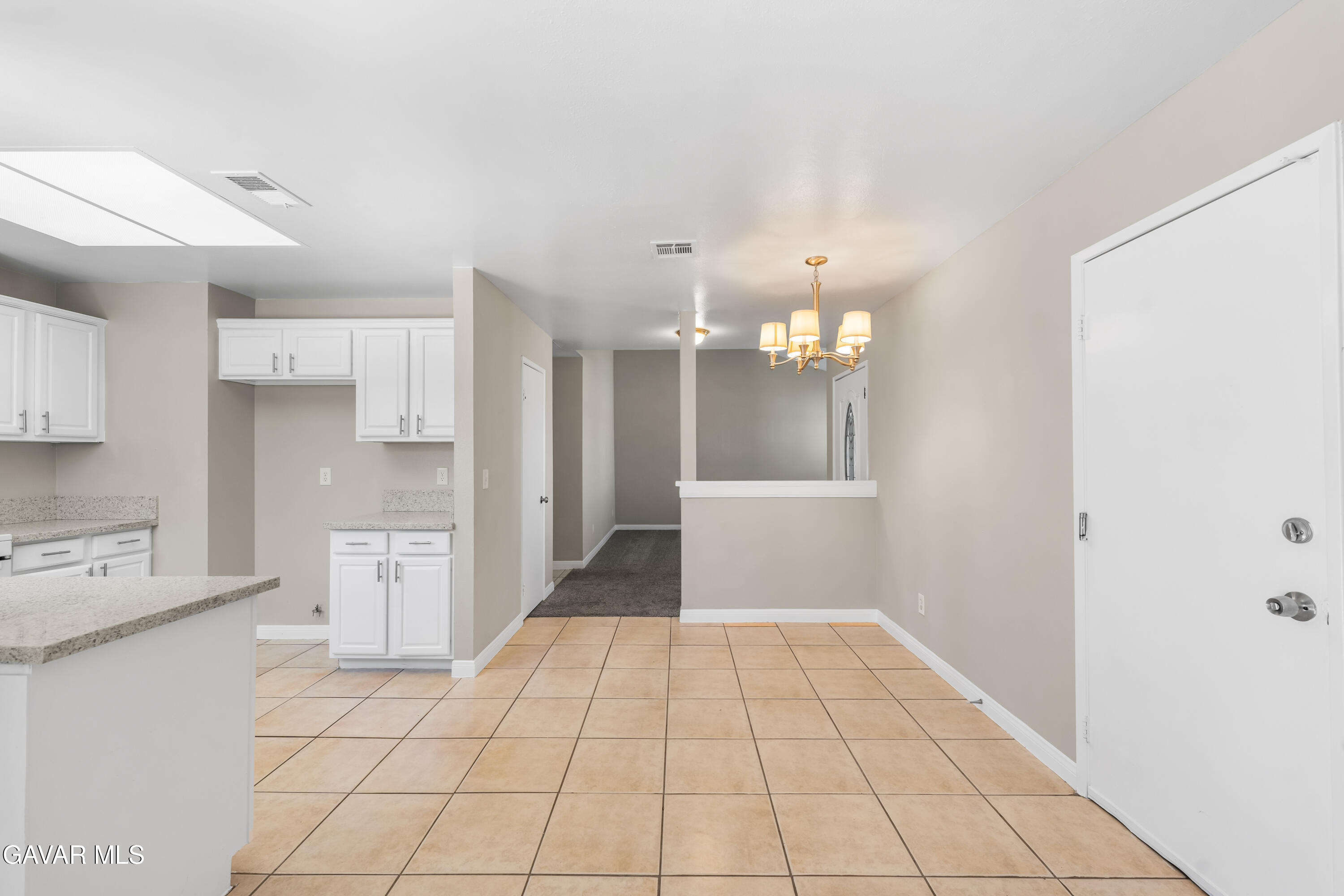 39056 Dianron Road Palmdale, CA 93551 - Photo 11 of 35 a view of a kitchen with white cabinets