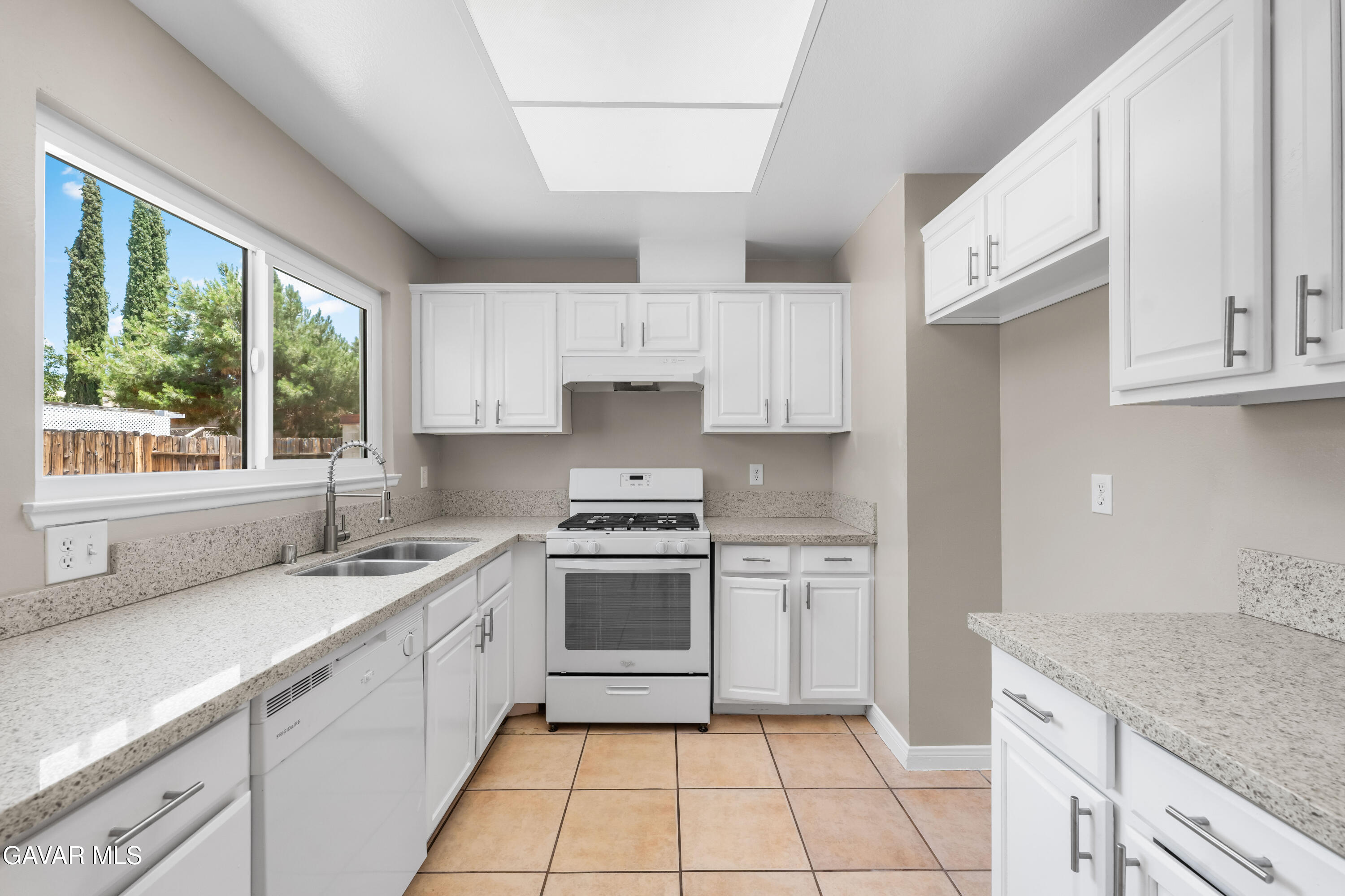 39056 Dianron Road Palmdale, CA 93551 - Photo 13 of 35 a kitchen with a sink stove top oven and cabinets