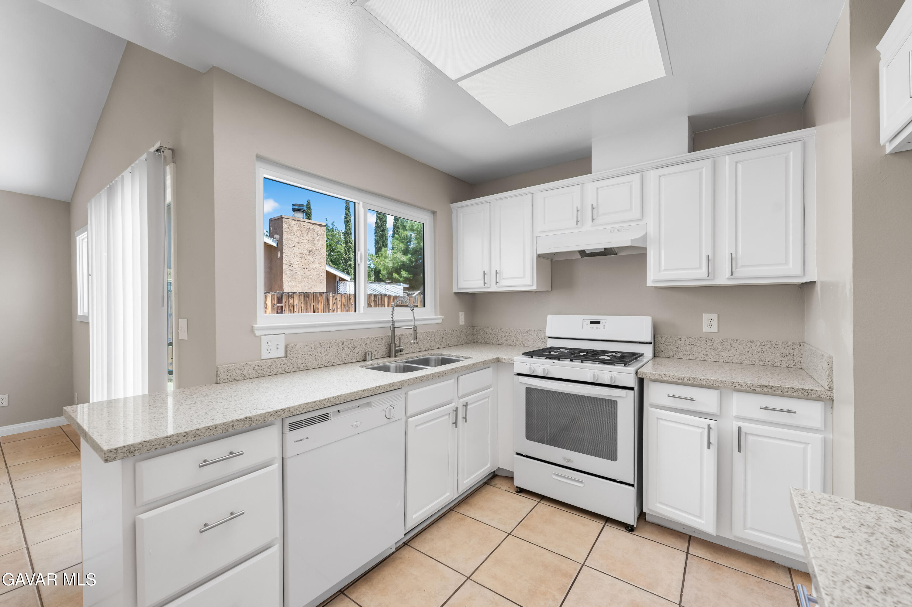 39056 Dianron Road Palmdale, CA 93551 - Photo 14 of 35 a kitchen with a stove sink and cabinets