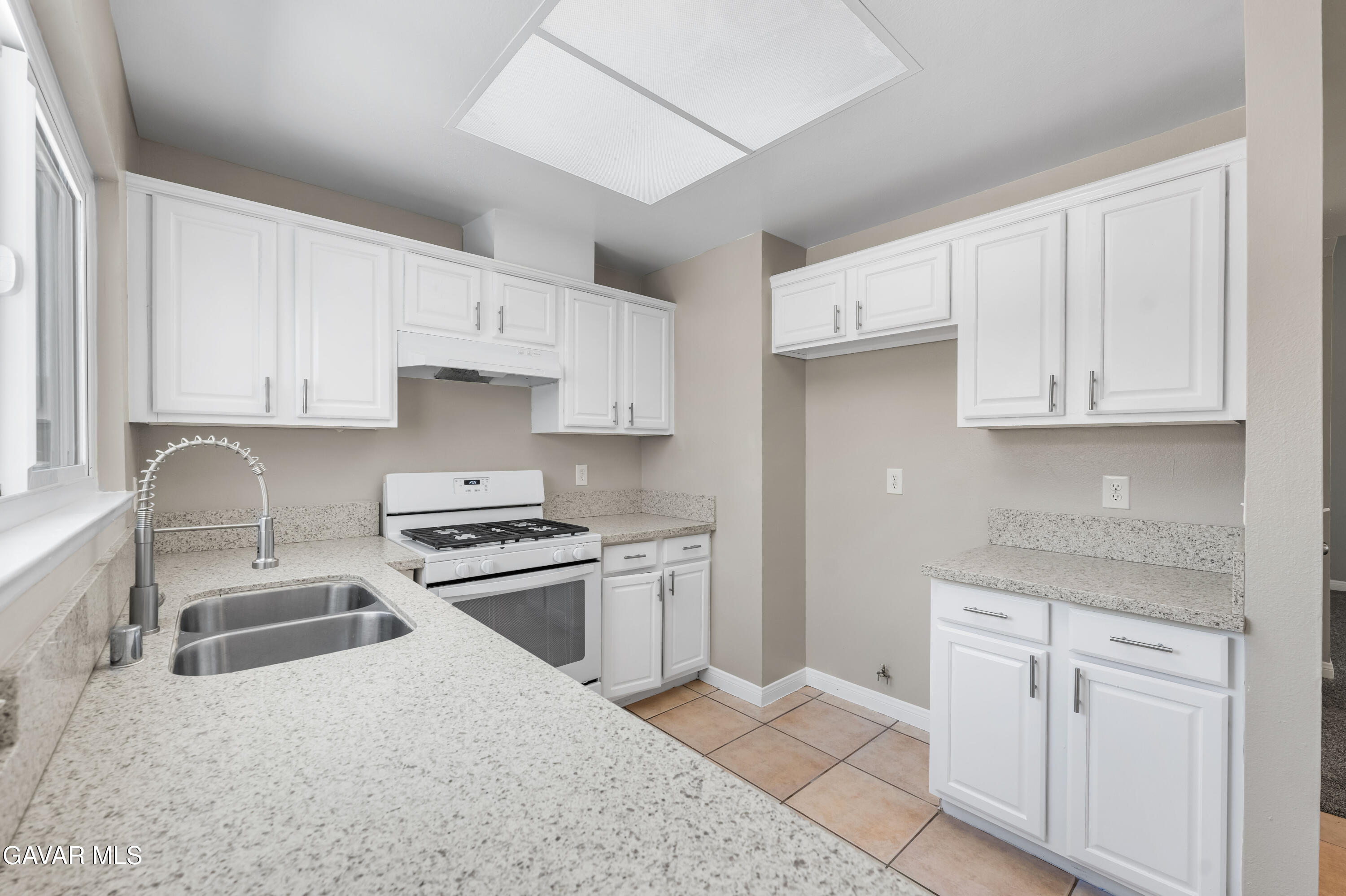39056 Dianron Road Palmdale, CA 93551 - Photo 15 of 35 a kitchen with cabinets appliances a sink and a counter top space