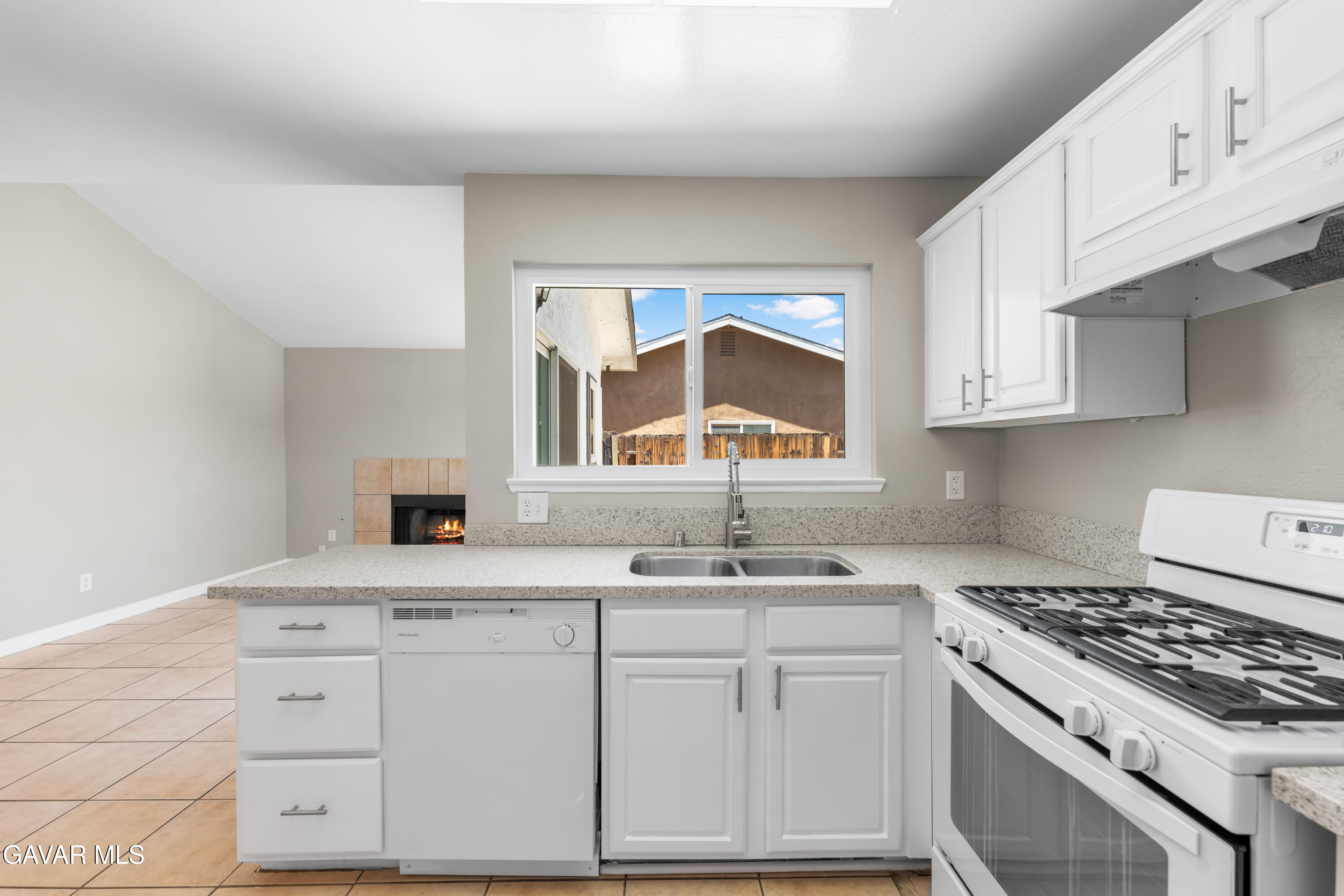 39056 Dianron Road Palmdale, CA 93551 - Photo 16 of 35 a kitchen with cabinets appliances a sink and a window