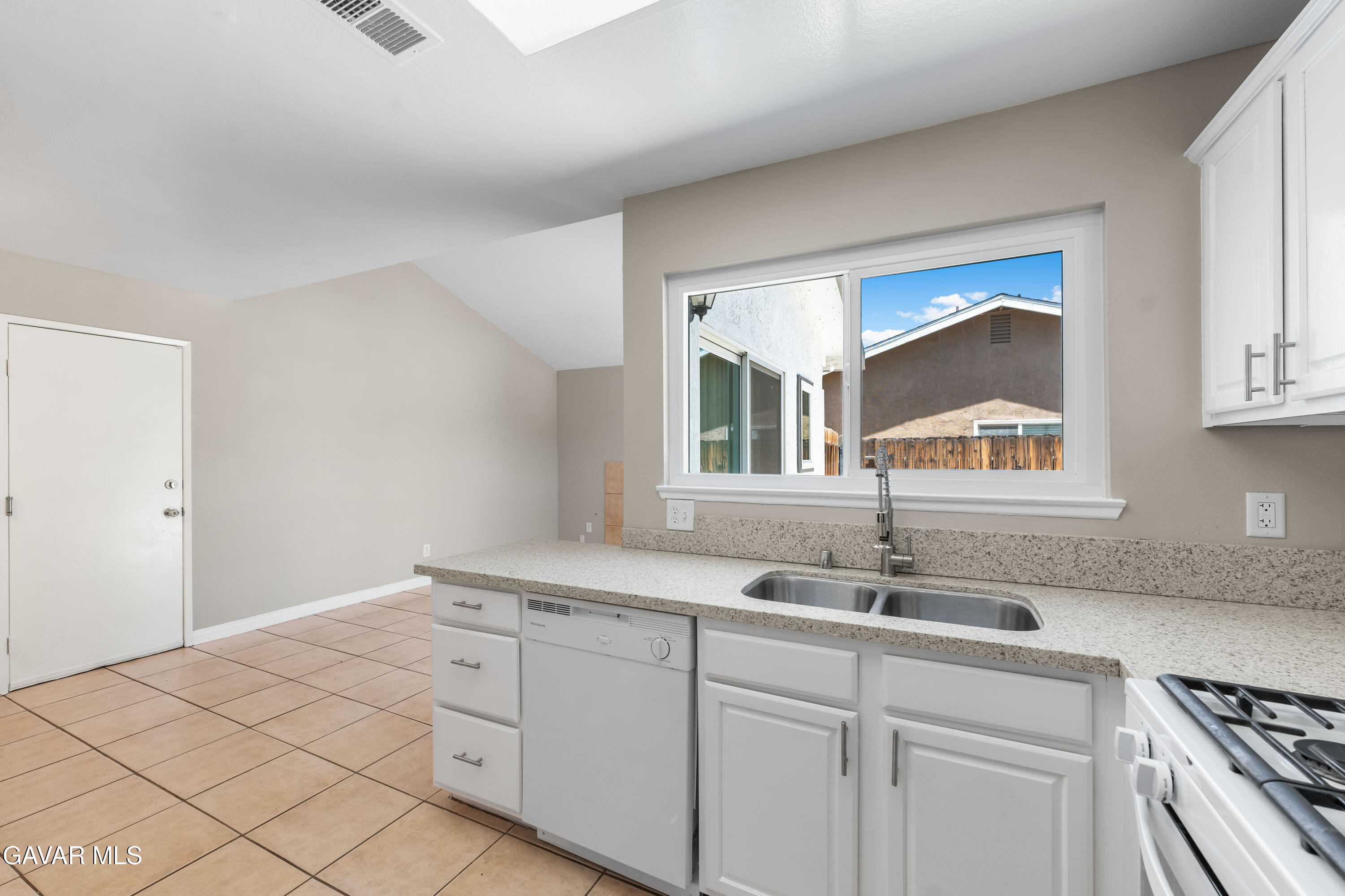 39056 Dianron Road Palmdale, CA 93551 - Photo 17 of 35 a kitchen with white cabinets and a sink