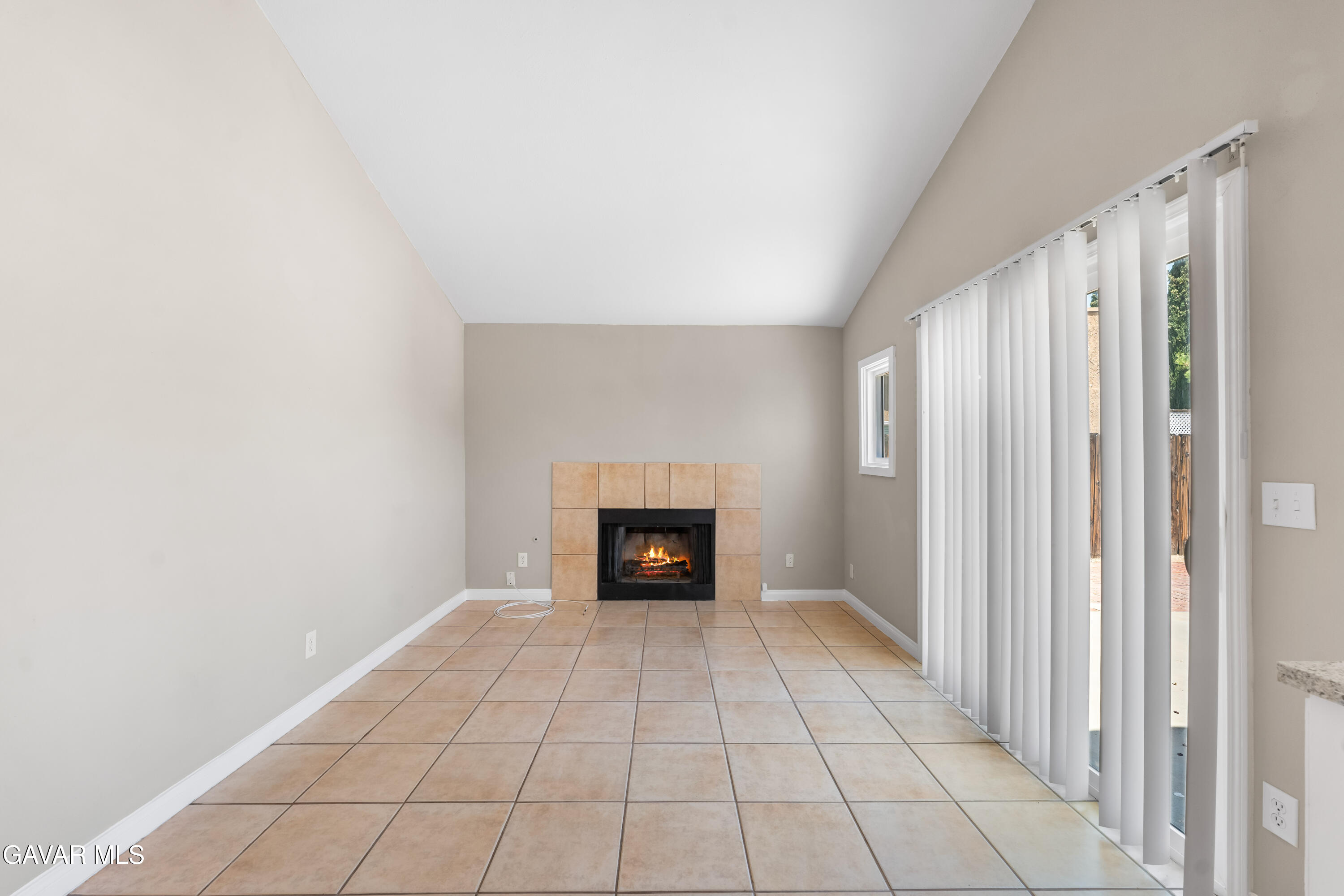 39056 Dianron Road Palmdale, CA 93551 - Photo 18 of 35 a view of an empty room with a fireplace and a window