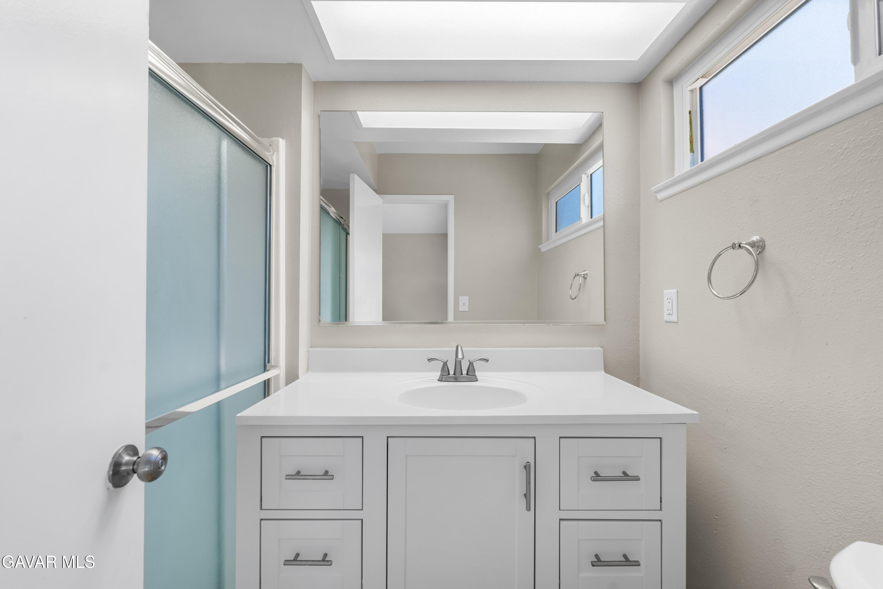 39056 Dianron Road Palmdale, CA 93551 - Photo 27 of 35 a bathroom with a sink and a mirror