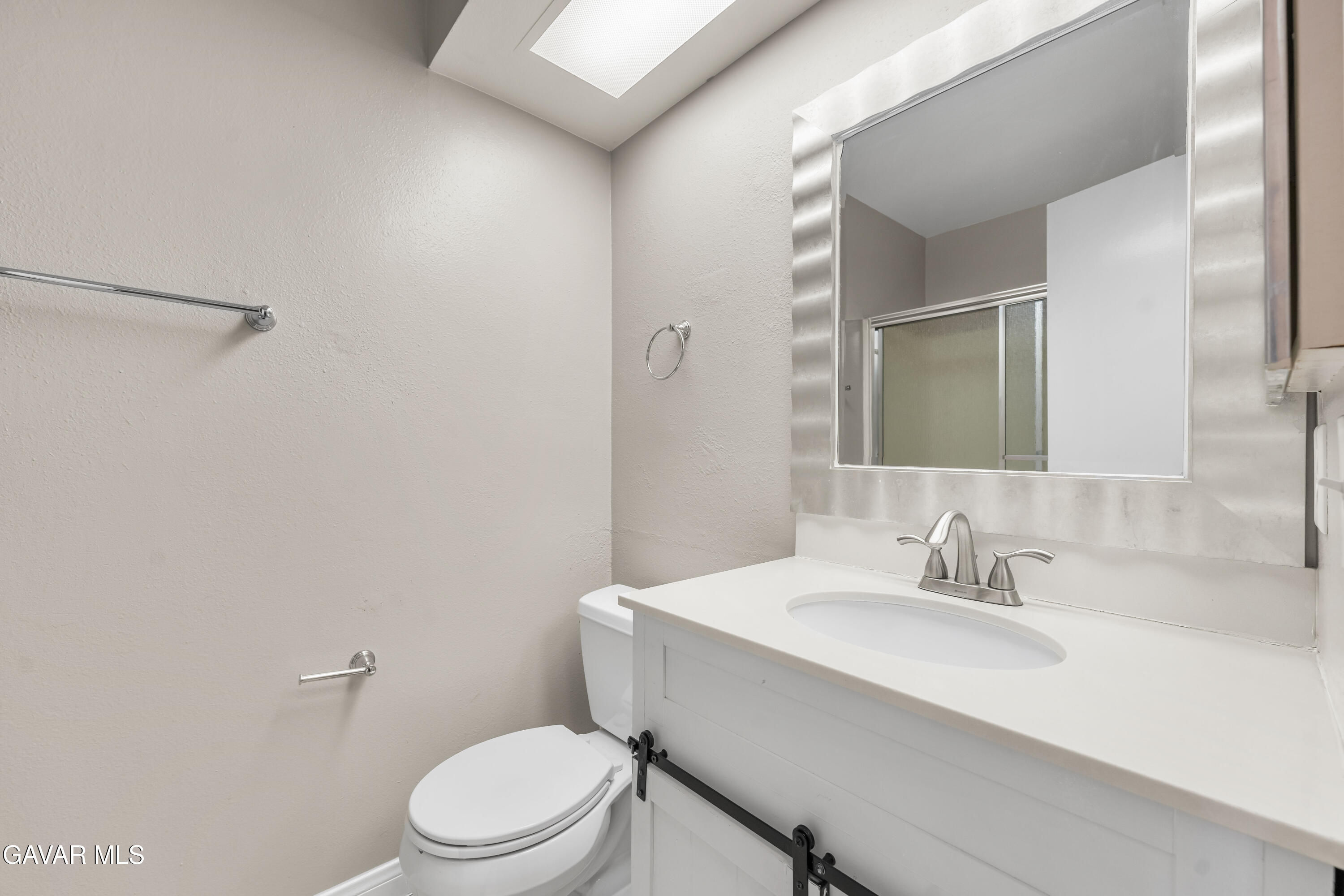 39056 Dianron Road Palmdale, CA 93551 - Photo 28 of 35 a bathroom with a sink a toilet and a mirror