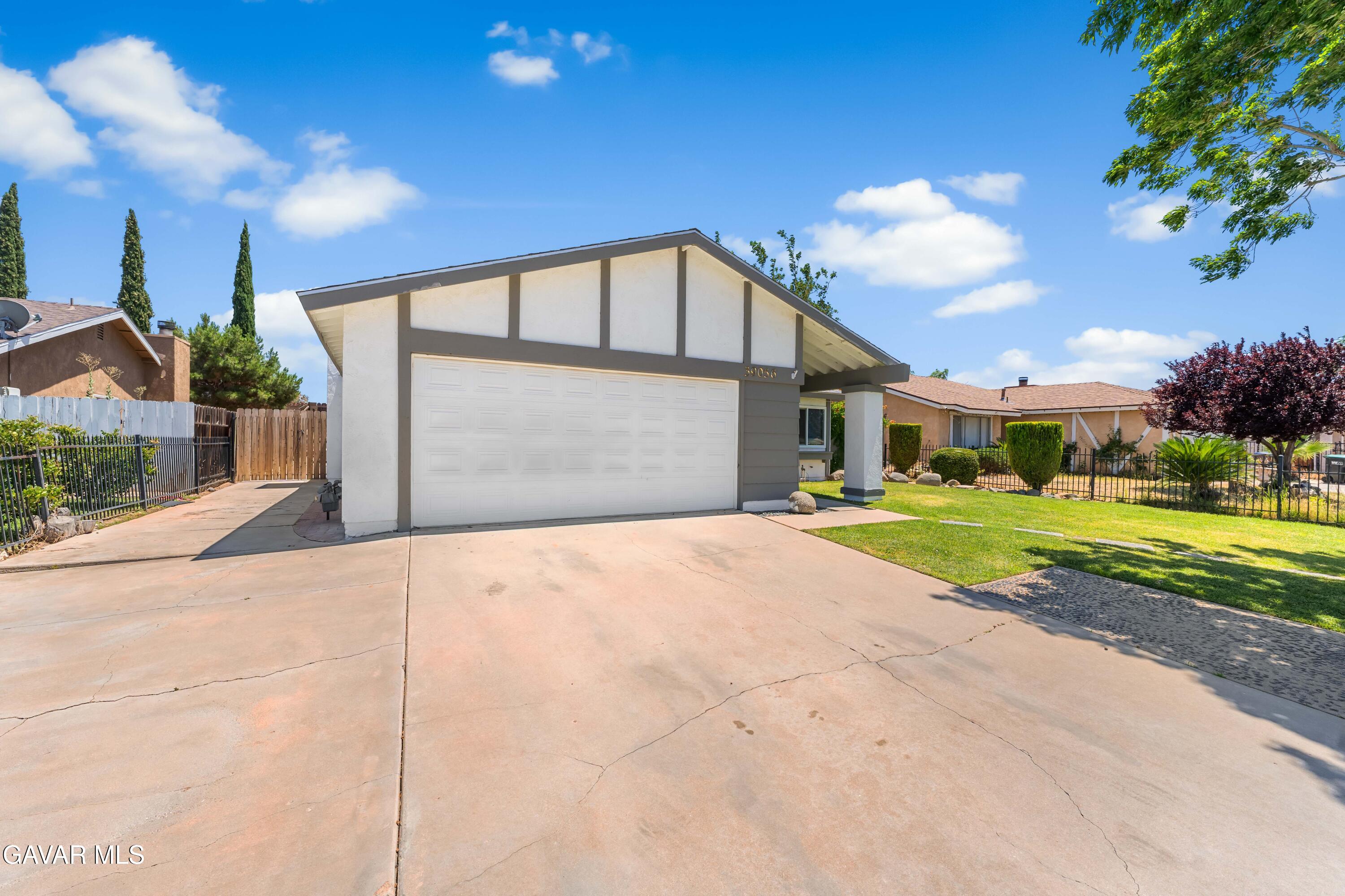 39056 Dianron Road Palmdale, CA 93551 - Photo 3 of 35 a view of a house with a yard and garage