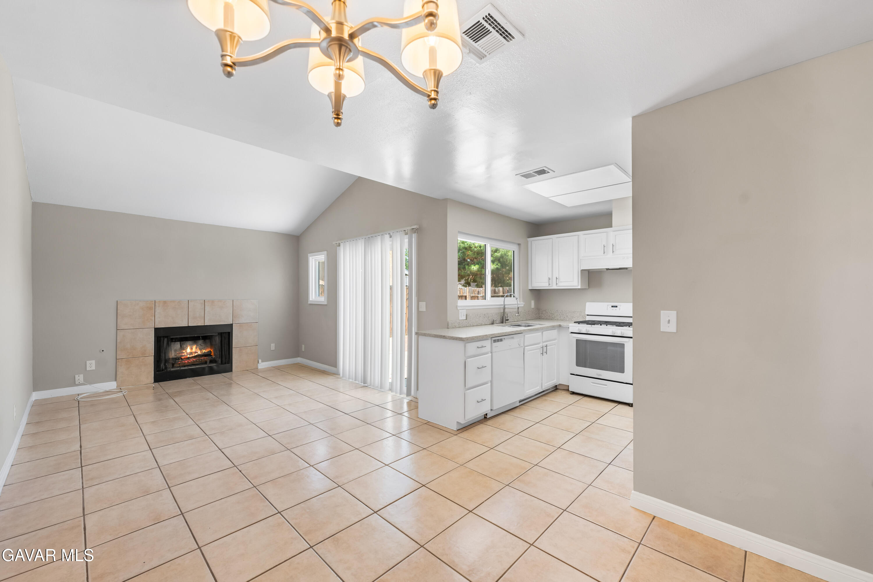 39056 Dianron Road Palmdale, CA 93551 - Photo 10 of 35 a kitchen with white cabinets and appliances