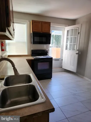 a kitchen with granite countertop a stove and a sink