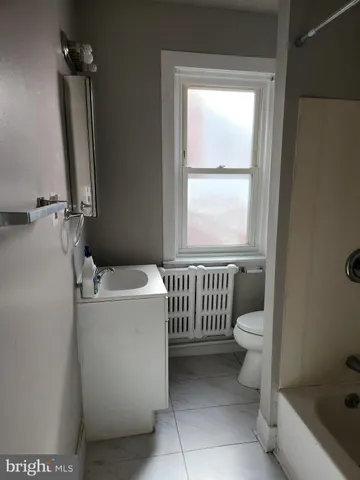 a bathroom with a toilet a sink and a bathtub