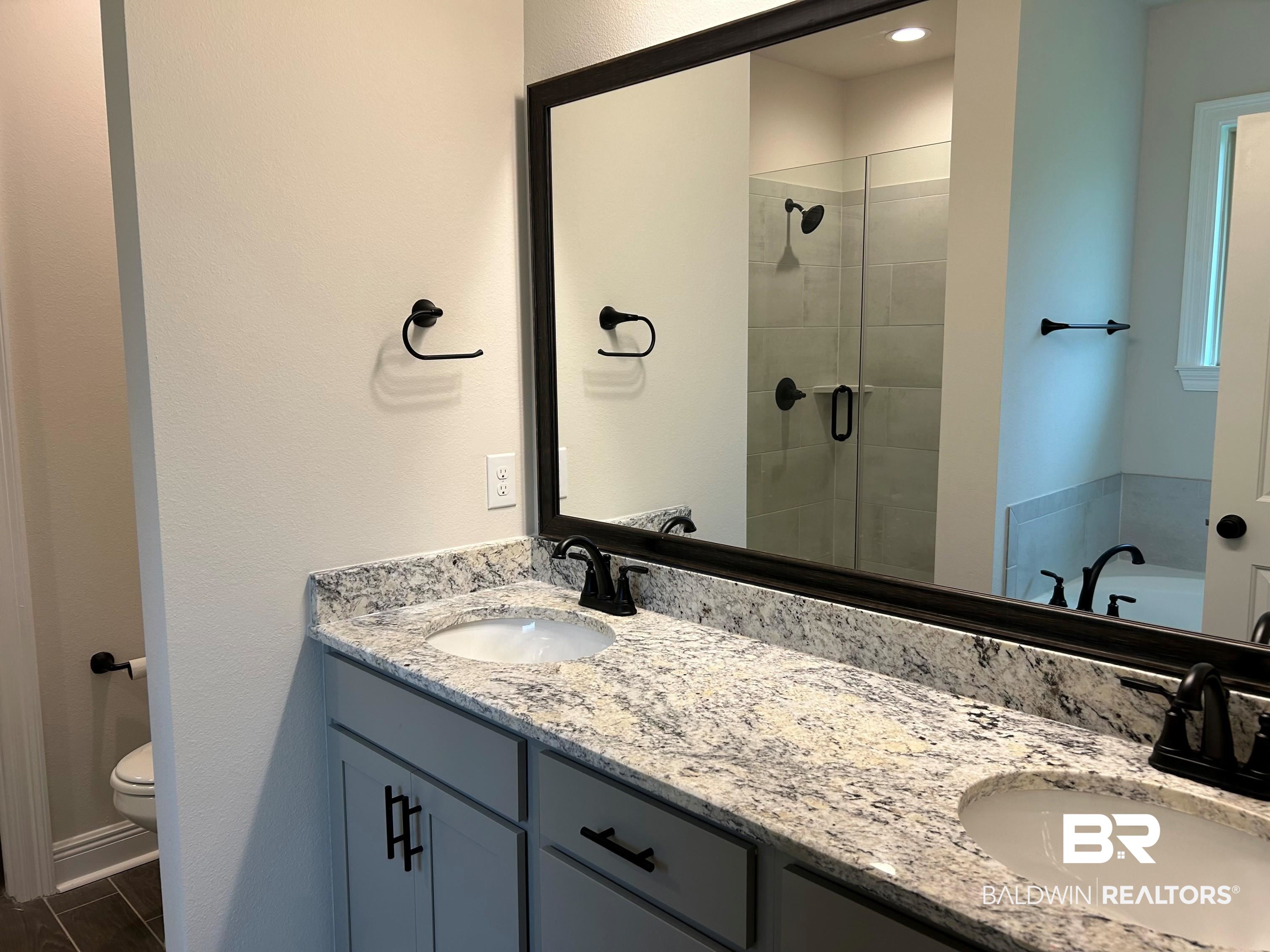 844 Sumter Loop Foley, AL 36535 - Photo 14 of 18 Bathroom featuring an enclosed shower, vanity, and toilet