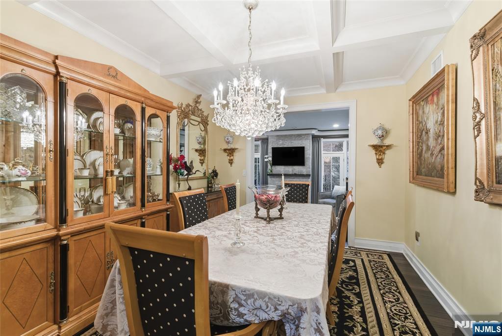 119 Hudson Cove Edgewater, NJ 07020 - Photo 14 of 44 a view of a dining room with furniture a chandelier and wooden floor