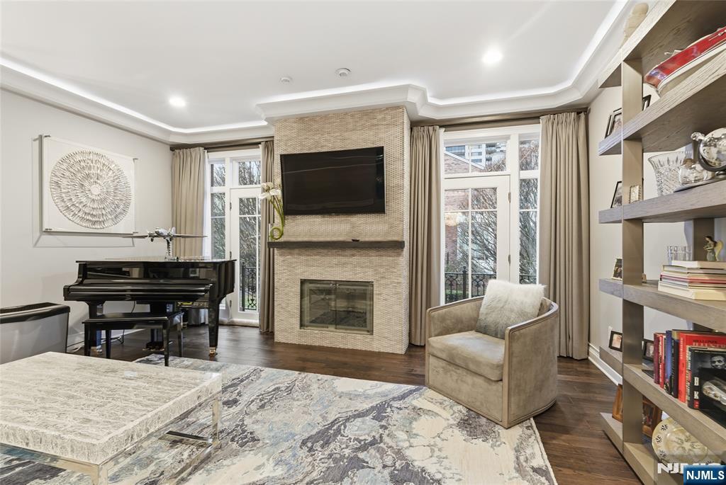 119 Hudson Cove Edgewater, NJ 07020 - Photo 17 of 44 a living room with furniture a fireplace and a flat screen tv