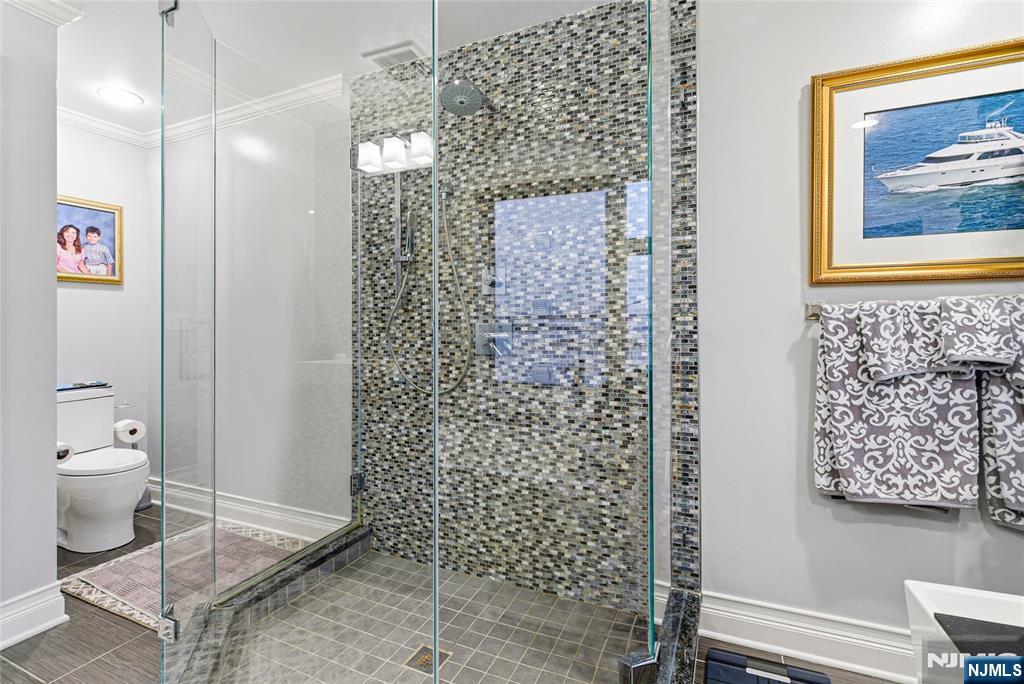 119 Hudson Cove Edgewater, NJ 07020 - Photo 28 of 44 a bathroom with a toilet and a shower