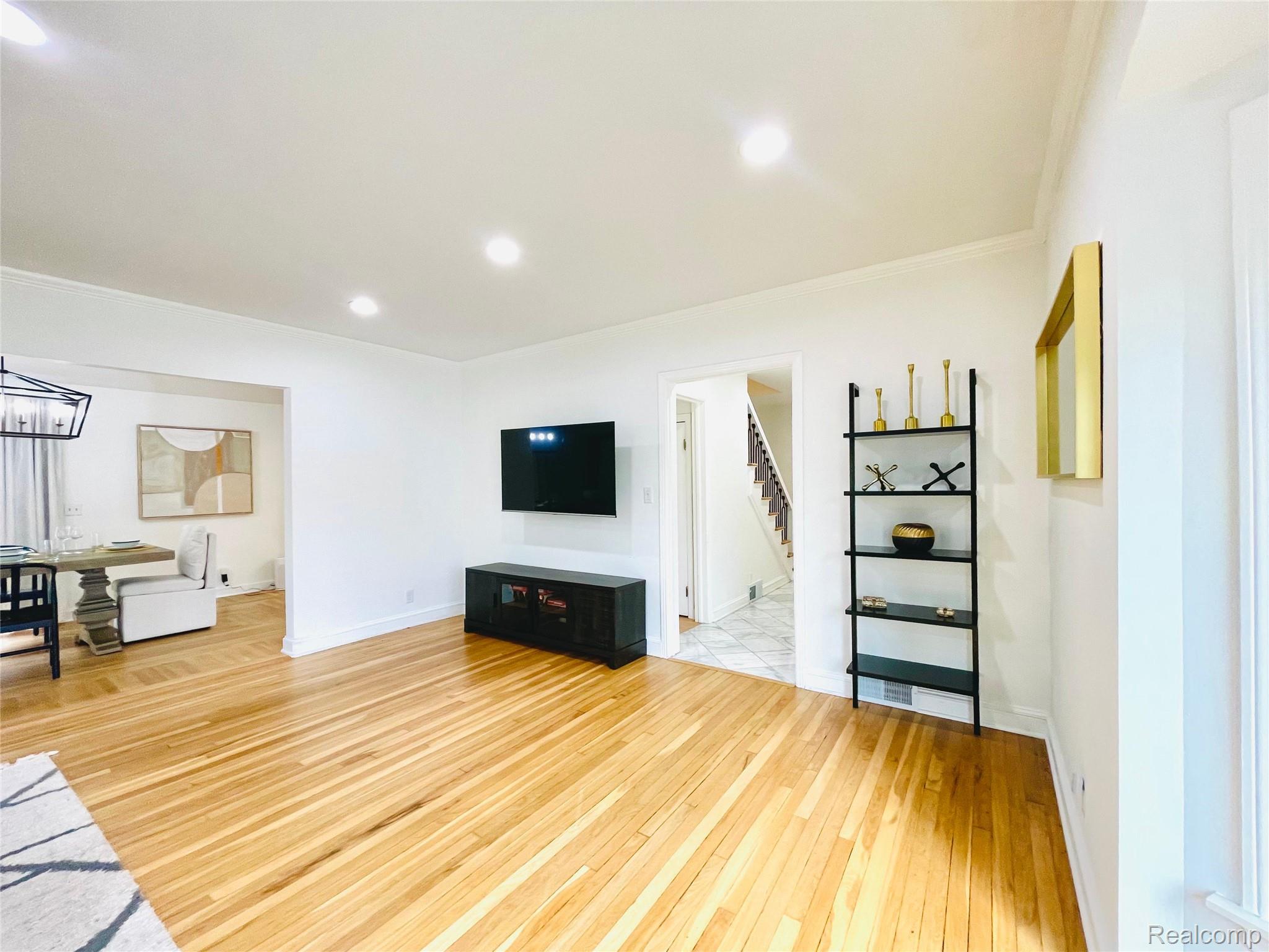 60 Devon Road Bloomfield Hills, MI 48302 - Photo 11 of 50 Wood-finish flooring throughout, recessed lighting, white walls, and crown molding