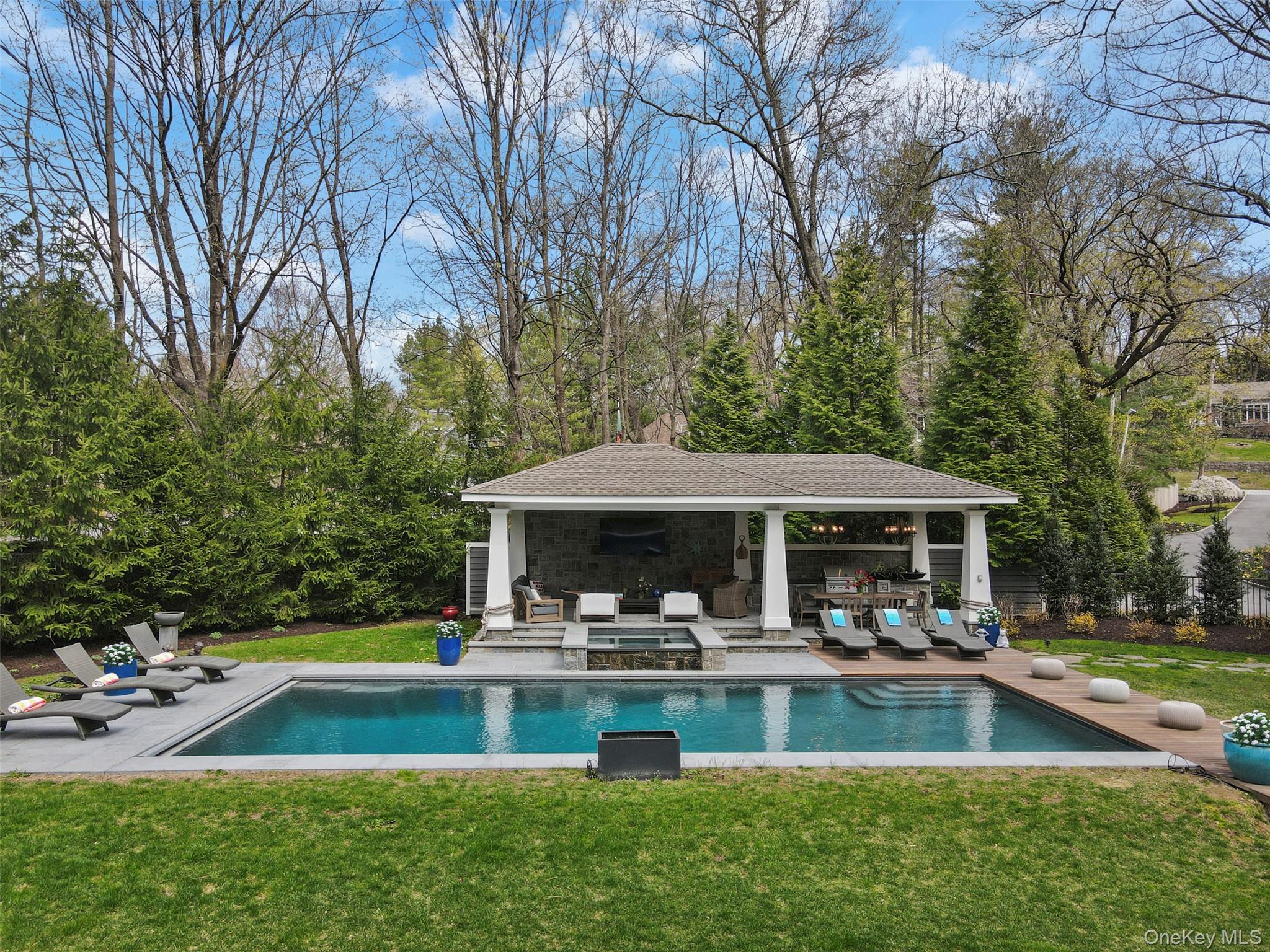 54 Lincoln Avenue Rye Brook, NY 10577 - Photo 2 of 38 a swimming pool with outdoor seating and yard