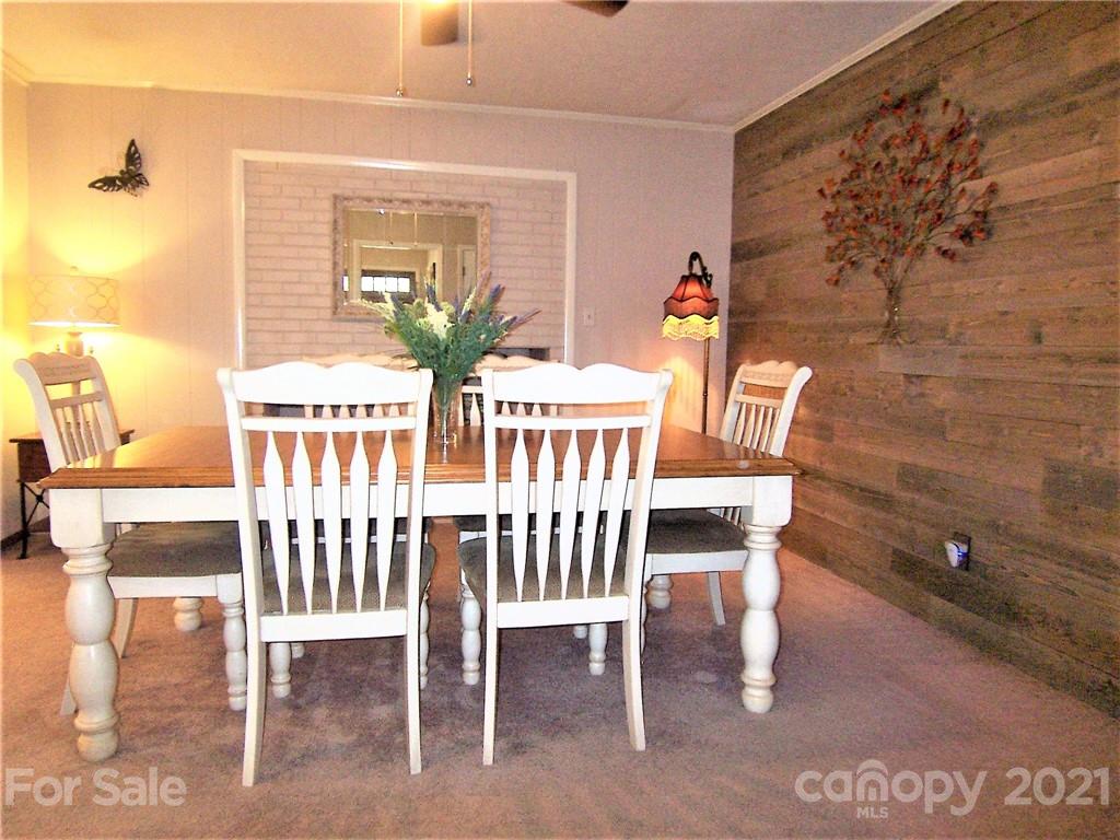 3536 Fallston Road Shelby, NC 28150 - Photo 12 of 34 a view of a dining room with furniture wooden floor and a chandelier