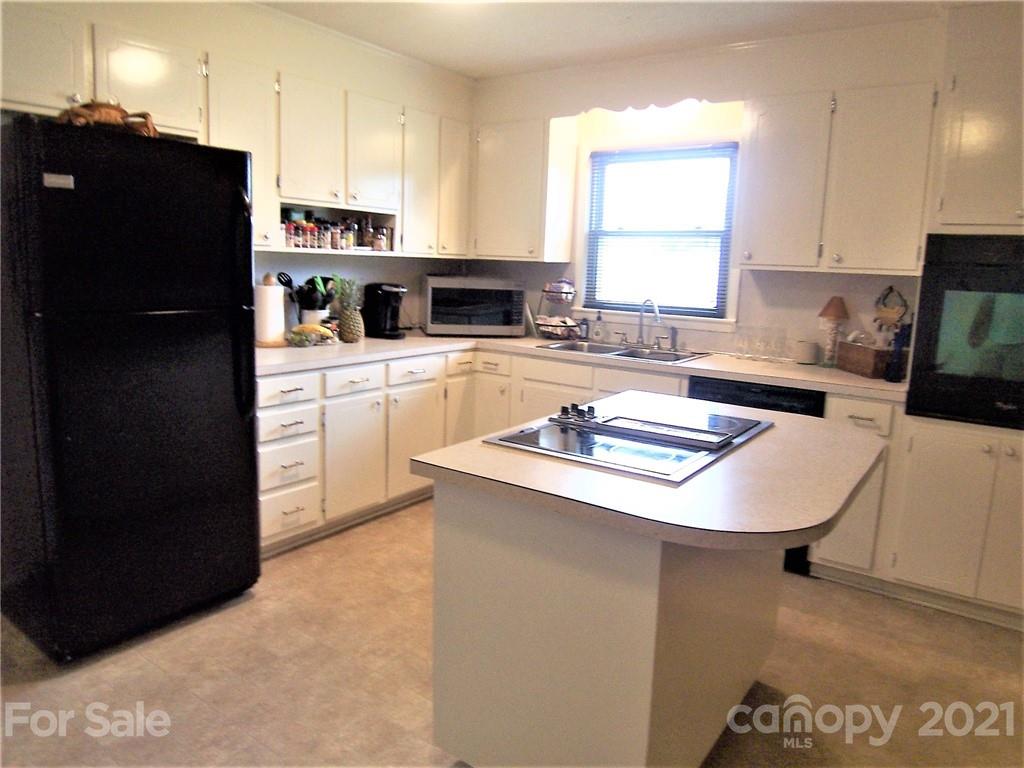 3536 Fallston Road Shelby, NC 28150 - Photo 17 of 34 a kitchen with a sink a stove a refrigerator and cabinets